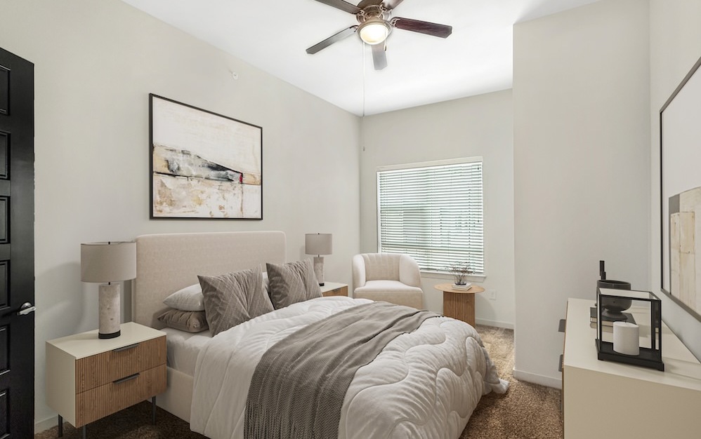 bedroom with a ceiling fan and large window
